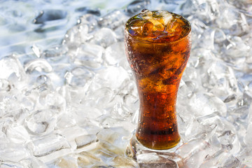 Glass of cola soda drink with ice cubes