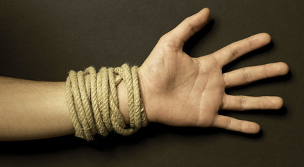 Hand with a rope with black background