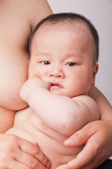 a cute little baby In the mother's arms.