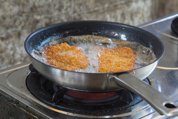 Breaded pork fried rice on a  gas stove