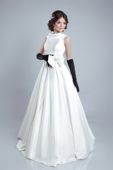 Fototapeta na wymiar Beautiful young bride woman posing in wedding dress isolated on