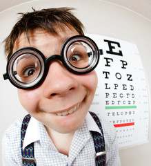Funny boy wearing spectacles in an office at the doctor