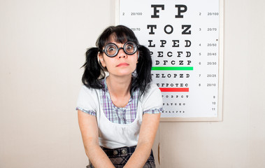 Funny woman wearing spectacles in an office at the doctor