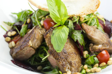 rabbit liver salad with arugula in a restaurant