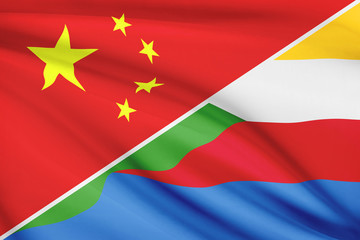 Series of ruffled flags. China and Union of the Comoros.