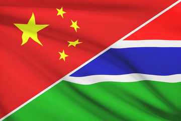 Obraz premium Series of ruffled flags. China and Republic of the Gambia.
