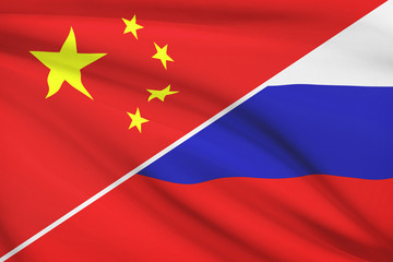 Series of ruffled flags. China and Russian Federation.