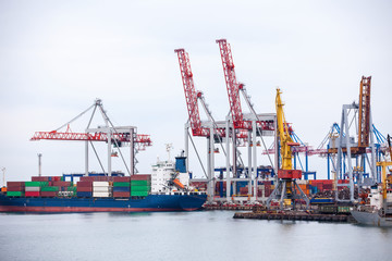 Fototapeta premium Ship in the dock with elevating cranes