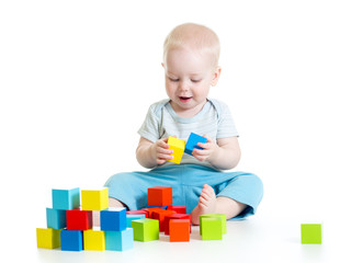 Child boy playing toy blocks isolated on white background