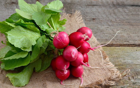 Heap of a garden radish on a wooden board