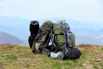 tourist's equipment on meadow in mountains