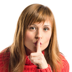 Naklejka premium Young girl making silence gesture over isolated white background