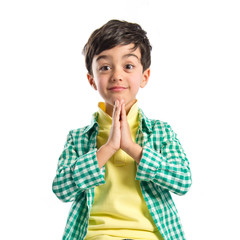 Brunette boy pleading over isolated white background