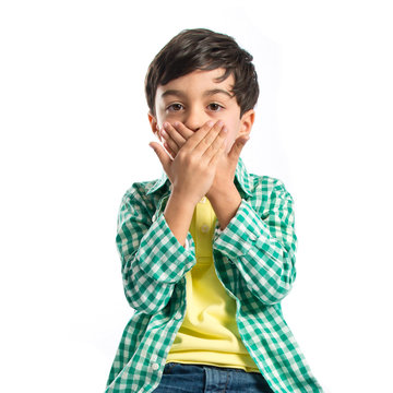 Kid Covering His Mouth Over White Background