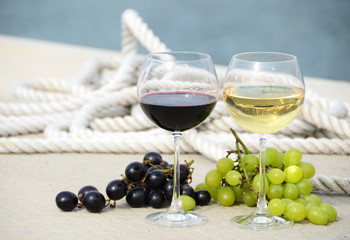 Wineglasses and grapes on the yacht pier of La Spezia, Italy