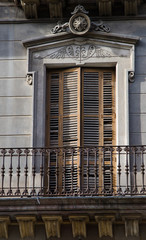 Balcony with metal railing and wood doors in Spain