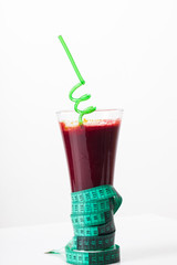 fresh squeezed juice for a healthy diet with measuring tape 