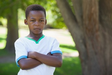 Little boy frowning at camera with arms crossed in the park © WavebreakMediaMicro