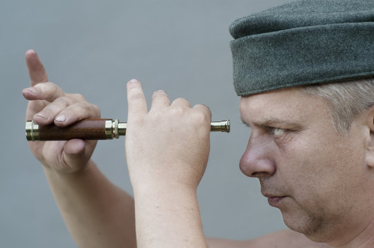 man holding  a spyglass