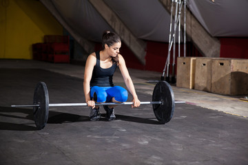 Fototapeta na wymiar Cute girl lifting weights