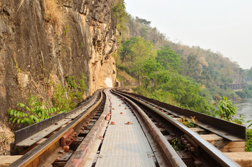 Fototapeta na wymiar Dead railway beside cliff, along Kwai river in Thailand