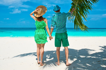 Couple in green on a beach at Maldives