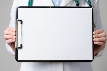 Doctor showing blank clipboard