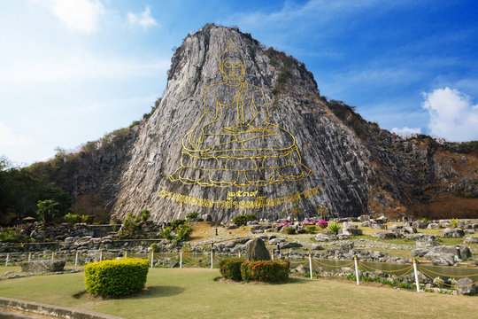 Carved golden buddha image on cliff at Khao Chee Jan, Thailand