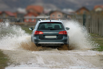Car drives through water