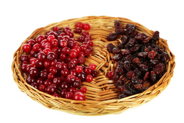 Fresh and dry cranberry on wicker mat, isolated on white