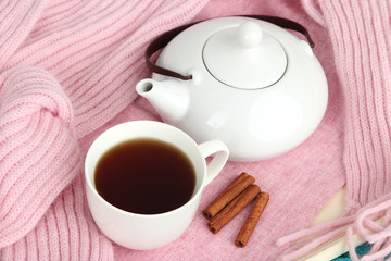 Cup and teapot on tray with scarf close up