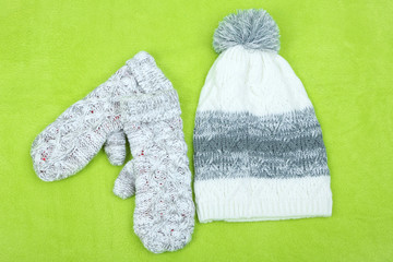 Winter cap and gloves,  on color background