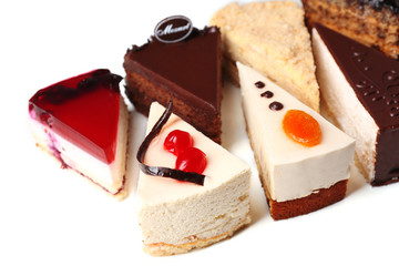 Assortment of pieces of cake, isolated on white © Africa Studio