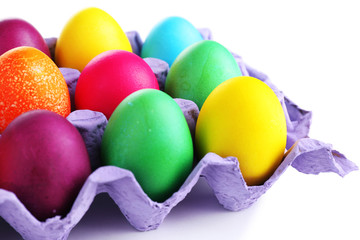 Colorful Easter eggs in tray isolated on white