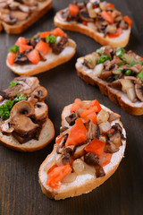 Delicious bruschetta with mushrooms on table close-up