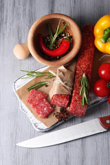 Tasty salami sausage, vegetables and spices