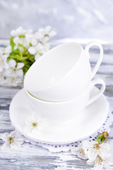 Beautiful fruit blossom in glass on table on grey background