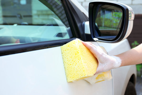 Outdoor car wash with yellow sponge