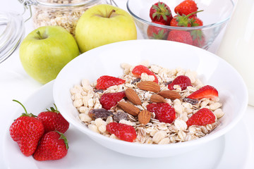 Healthy cereal with milk and fruits close up