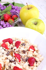 Healthy cereal with fruits on wooden table
