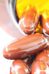 Brown pills and pill bottle.