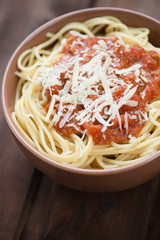 Spaghetti bolognese with parmesan cheese, vertical shot