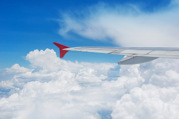 Fototapeta na wymiar Wing of an airplane flying in the sky