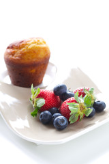 Muffin, strawberries and blueberries