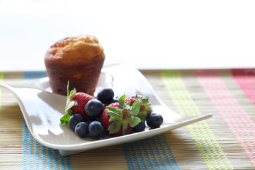 Muffin, strawberries and blueberries
