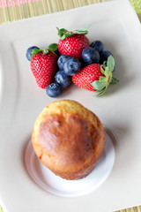Muffin, strawberries and blueberries