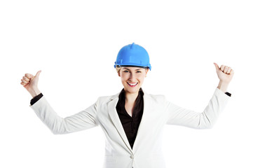 Portrait of confident young female architect standing arms up th