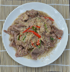Pork with sesame seeds.