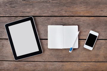 tablet and smartphone on wooden desk