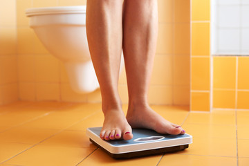 A pair of female feet on a bathroom scale